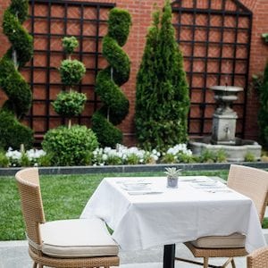 Table set for two in the courtyard at Magdalena Restaurant.